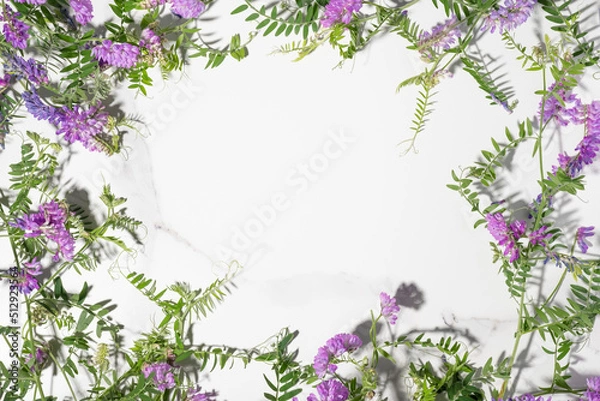 Fototapeta Flower frame with white space background. Beautiful blooming meadow composition. Greeting card, wedding, summer, spring, Mother's day, Valentines, birthday party invitation. Green leaves and pink buds