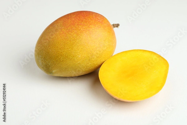 Fototapeta Mango fruit with mango slice placed on a white background