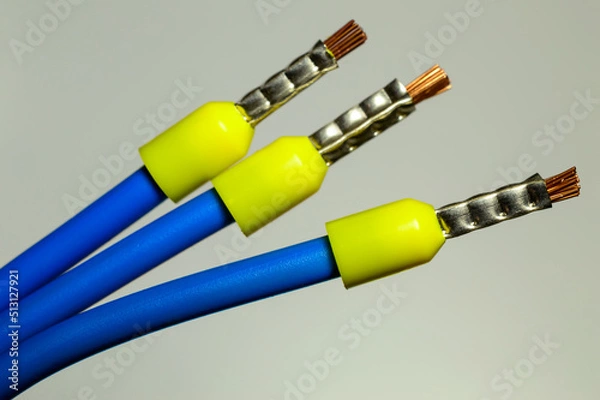 Fototapeta Blue wires with yellow ferrules - macro photo. Background picture. Selective focus.