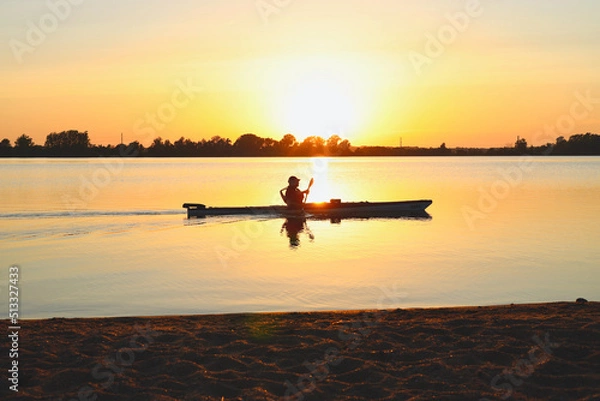 Obraz Person kayaking on a lake at sunset