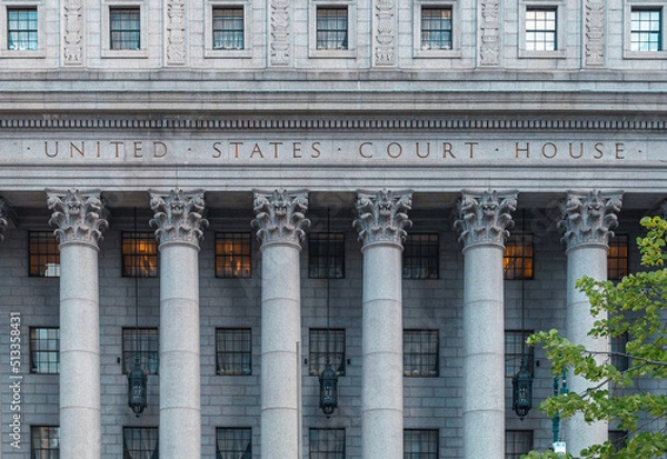 Fototapeta The main entrance of the Thurgood Marshall US Courthouse in NYC is listed on the National Register of Historic Places. The Corinthian columns and the frieze are carved with a detailed floral design.