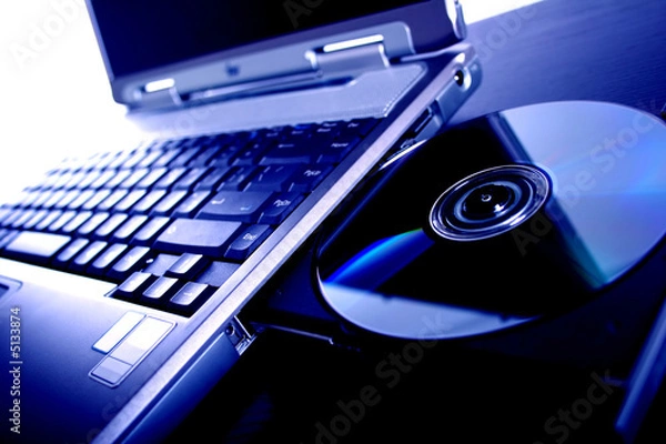 Obraz laptop with a disk dvd. blue tone