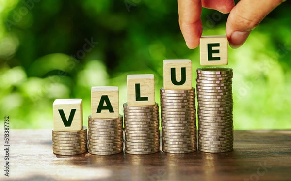 Fototapeta Wooden cubes with value word on stacked of coins in stair shape on nature background.             