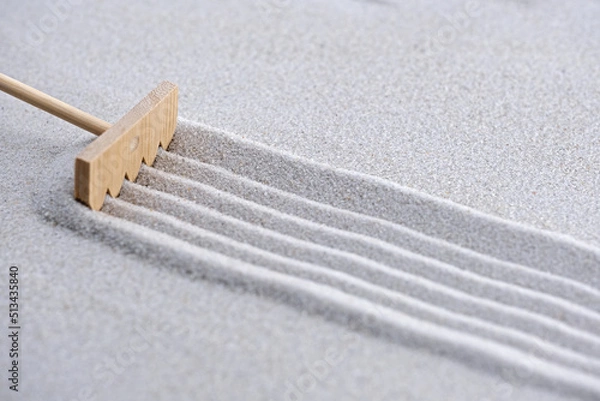 Obraz pattern in the sand with zen garden tool, a rake