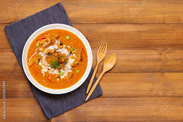 Obraz Thai red curry with Chicken on wood background - Top view