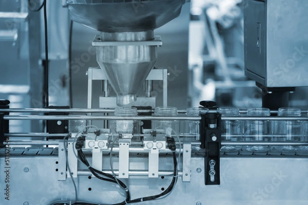 Fototapeta Solid , Semi solid filling machine for industry. Industrial Solid , Semi solid filling Machine for quality of product in line conveyor processing. Industrial and factory technology concept.