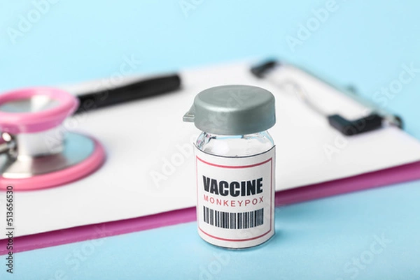 Fototapeta Monkeypox vaccine on blue background, closeup