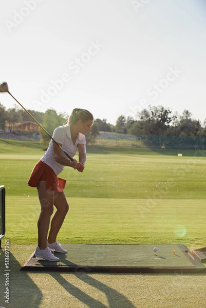 Fototapeta beautiful girl makes a hit while playing golf
