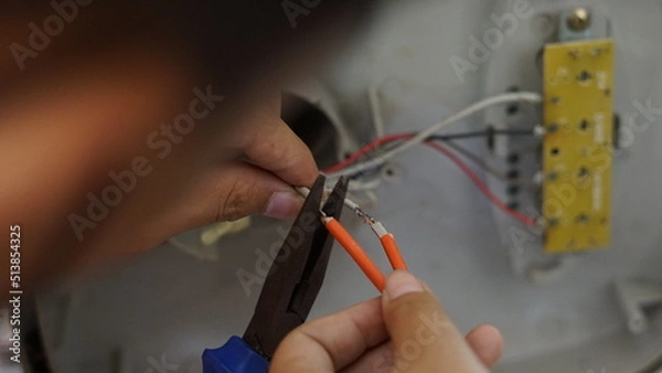 Obraz Electrical appliance, Electrician, The technician is repairing the electrical appliances in the house to return them to normal operation.