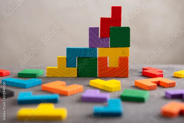 Fototapeta Creative idea solution - business concept, jigsaw puzzle on the grey background. Leadership and teamwork strategy success.
