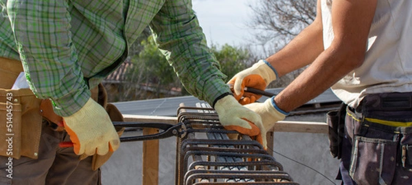 Obraz bricklayers with yellow helmet and protective glasses building an iron beam for reinforced concrete - PHOTO SESSION: WORK IN CONSTRUCTION