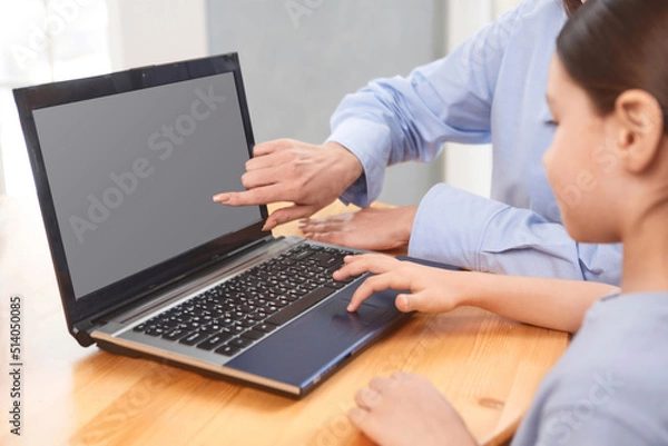 Fototapeta teacher with student doing online lessons, online education concept, online learning with kids at home
