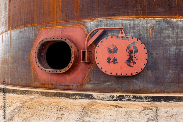 Obraz Opened rusty manhole on the fuel tank shell storage tank. High quality photo