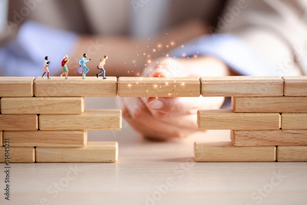 Obraz miniature figure running on wood block crossing bridge