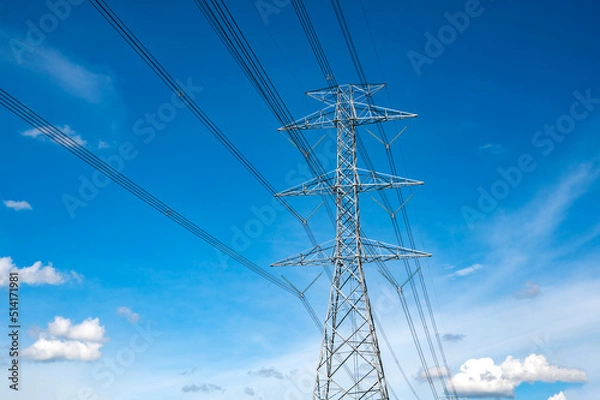 Fototapeta Standing street light post, electric pole and high voltage tower.High voltage transmission pole sunlight with blue sky background.