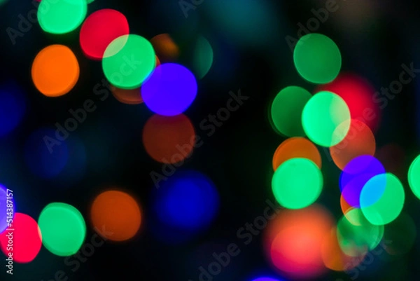 Fototapeta Multi-colored lights with red, green, purple, orange colored on the dark background. The whole shot is strong defocused to use bokeh simulation.
