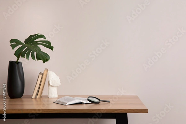Obraz The stylish composition of cozy office interior with copy space, vase with leaf, wooden table and personal accessories. Home decor. Template.