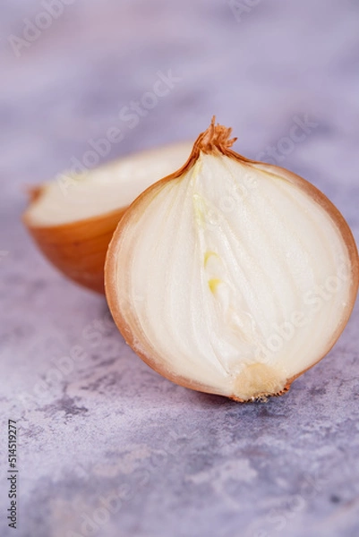 Fototapeta A halved onion on a marble surface background.