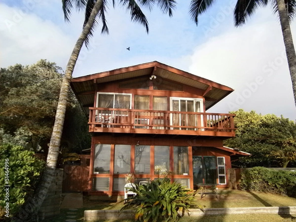 Fototapeta Red Beach House with tall coconut trees on Oahu, Hawaii