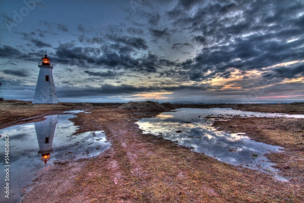 Fototapeta lighthouse with cloudy reflections