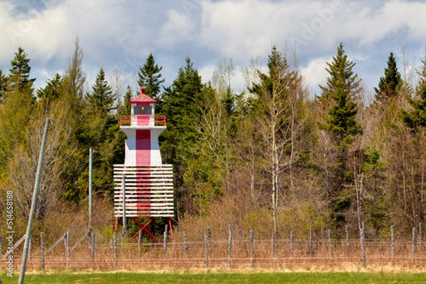 Fototapeta range lighthouse against forest
