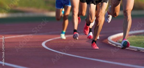 Fototapeta Athletics people running on the track field.Running a race on a track for sports competition and winning