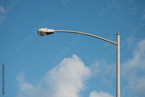 Fototapeta street lamp post with blue sky and white clouds
