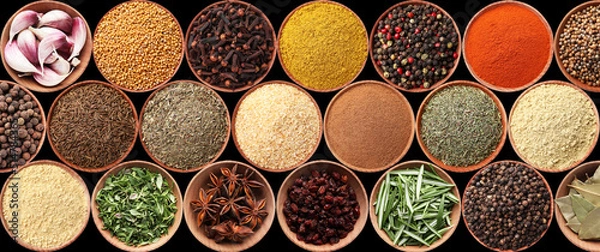 Fototapeta Collection of different aromatic spices and herbs on black background, flat lay. Banner design