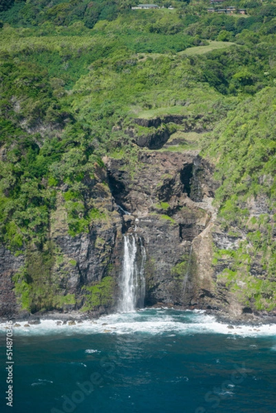 Fototapeta An aerial view of a waterfall spilling into the ocean on the coast of the island of Maui, Hawaii.