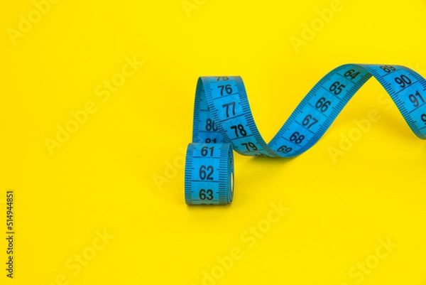 Fototapeta Spiral tape measure colorful background with copyspace