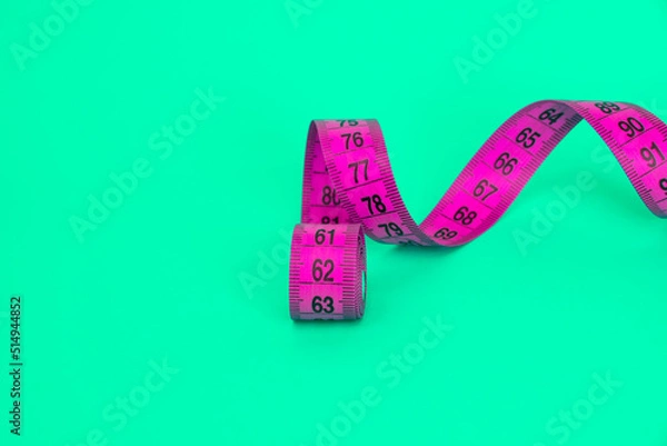 Fototapeta Spiral tape measure colorful background with copyspace