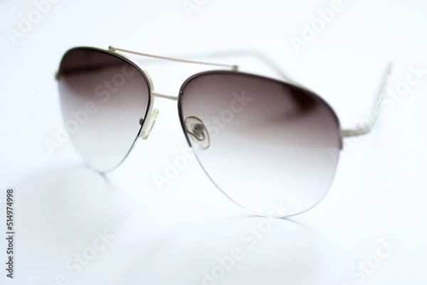 Obraz Glasses with gradient filled lenses, aviator glasses on a white background, selective focus