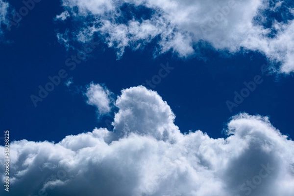 Fototapeta Dense clouds on a blue-sky form patterns. 