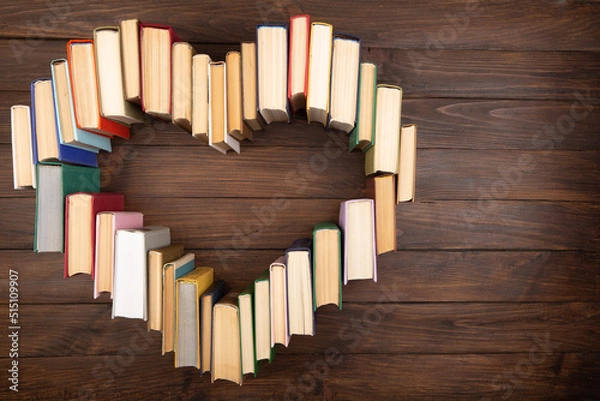 Fototapeta Love of reading concept. Book heart on the wooden background. Copy space for text