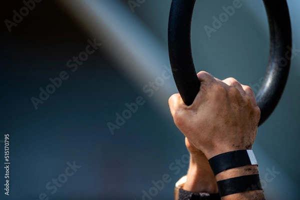 Fototapeta Athlete using gymnastics rings. Horizontal sport theme poster, greeting cards, headers, website and app