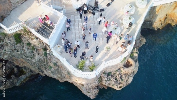 Obraz Top view of people celebrating wedding on the cliff. Drone aerial view