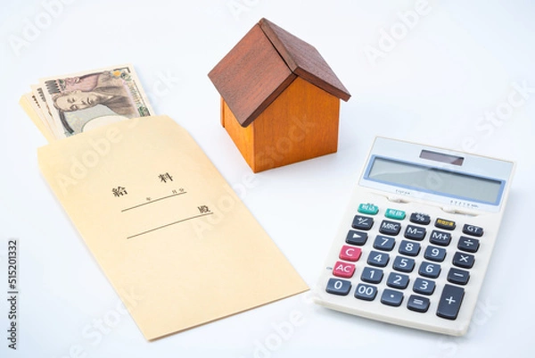 Fototapeta 住宅ローン返済・不動産購入のイメージ（給料と家の模型と電卓）