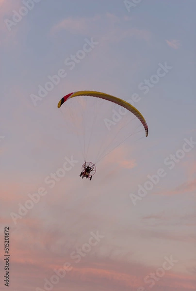 Obraz Aerial view on aeroplane in rose orange sunset sky