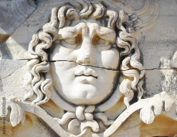 Fototapeta Closeup of a face carved on marble in classical style by ancient Greeks at the Temple of Apollo in Didyma. An impressive ruined sanctuary or statue in Hellenic city of Miletus, in southwest Turkey