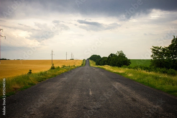 Obraz Road with a dark rainy sky.