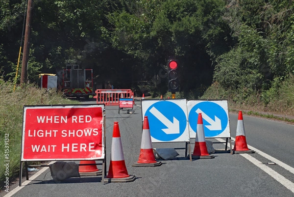 Fototapeta Waiting at a red light at roadworks controlled by traffic lights in Somerset, England. No traffic is approaching from the opposite direction
