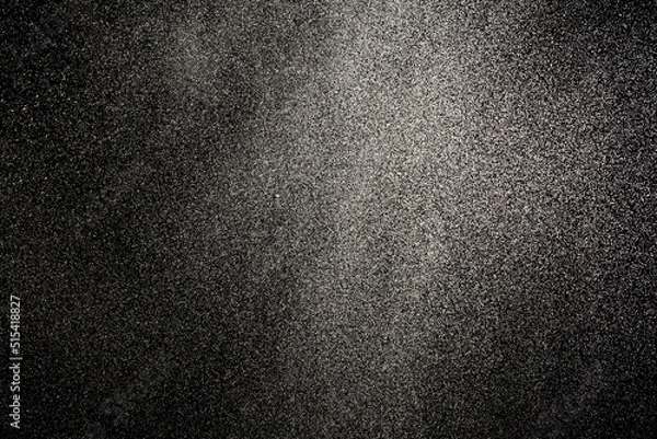 Fototapeta Sprayed water. Small droplets of water in the air. Lots of water drops, isolated on black background.