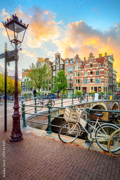 Obraz Amsterdam. Holland. Downtown of Amsterdam. Traditional houses and bridges of Amsterdam. A colorful sundown time.