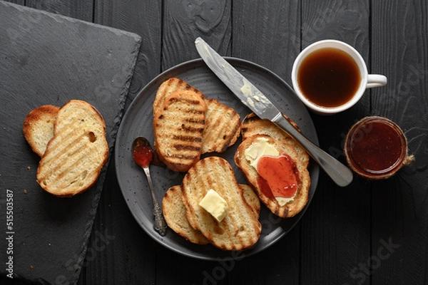 Fototapeta Continental Breakfast meal served with coffee, toast, jam and butter. Delicious coffee table.