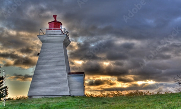 Fototapeta lighthouse with dramatic sunrise