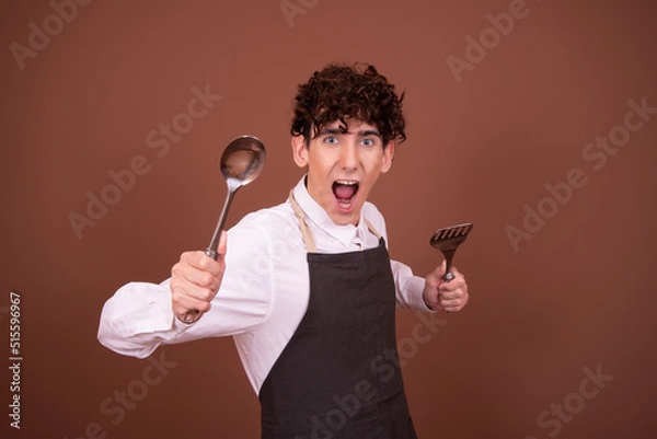 Obraz Funny young chef. Attractive guy.	