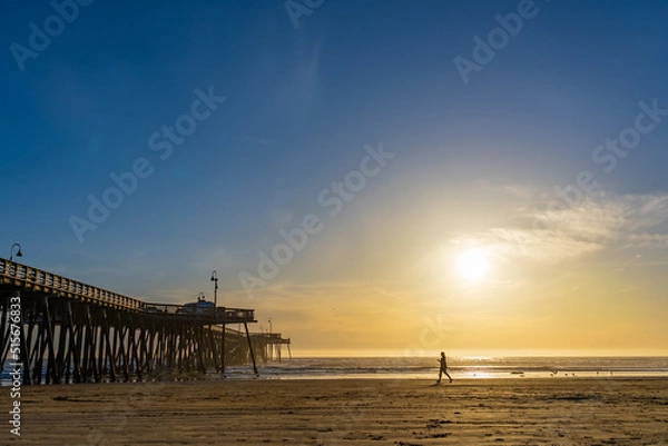 Obraz Lone Person Walking on Southern California Beach at Sunset Near Ocean Pier