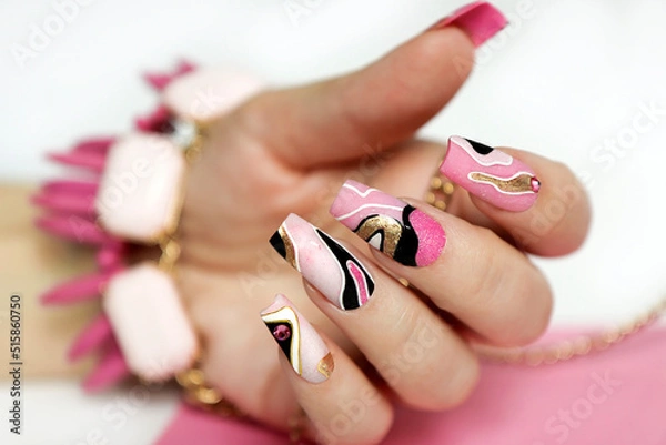 Obraz Manicure on short nails with rhinestones and golden lines.