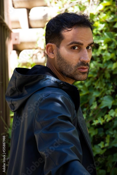 Fototapeta portrait of man looking at camera with jacket and hood