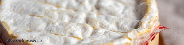 Obraz Sliced ​​piece of Camembert. Camembert close-up. Macro photography of cheese for the cover. Camembert advertisement. Cheese for the cover. Brie advertisement. Brie close-up. Cheese with mold close-up.